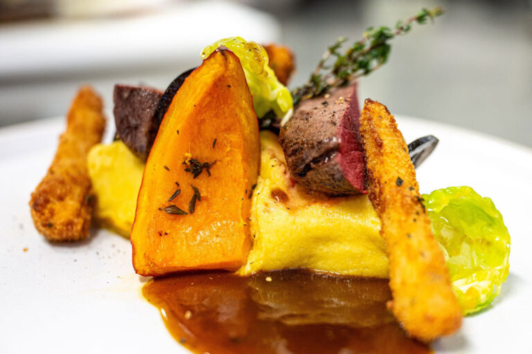 Rosa gebratener Rehrücken mit Ofenkürbis- Polenta, mariniertem Rosenkohl, Waldpilzen, gebackenem Sellerie, eingelegten Walnüssen und Preiselbeersauce